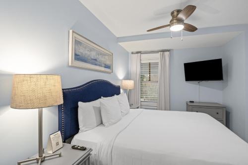 a bedroom with a large bed and a ceiling fan at Sandestin Golf and Beach Resort in Destin