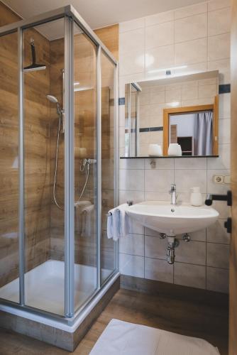 a bathroom with a shower and a sink at Apartpension Oberhauser in Kaprun