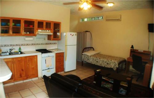 a kitchen with a white refrigerator and a sink at Pescadero Palace in El Pescadero