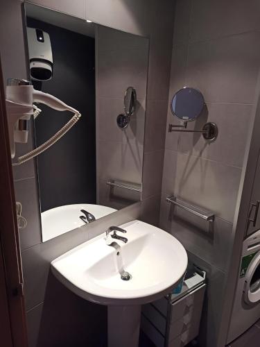 a bathroom with a sink and a mirror at Altissim LaSolana in Pas de la Casa