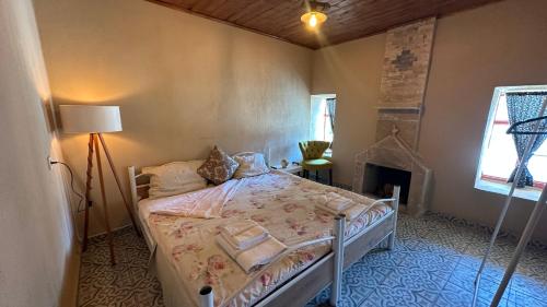a bedroom with a bed and a fireplace at Pergamon Yunt Evleri in Bergama