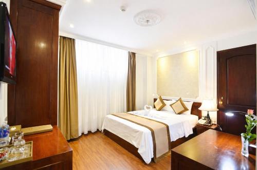 a hotel room with a bed and a window at Orange City Center Hotel Da Nang - Near Han Market & Dragon Brigde in Danang
