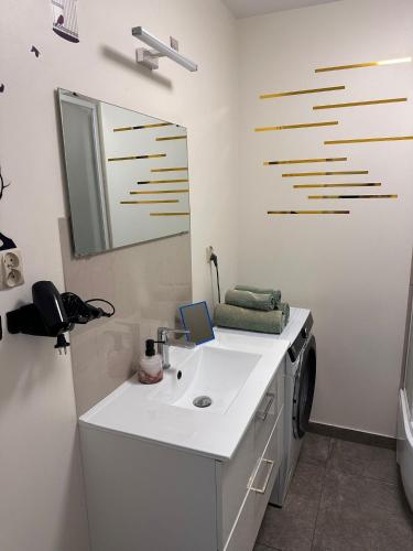 a bathroom with a sink and a washing machine at Metro Central 3 Rooms Apartment in Warsaw