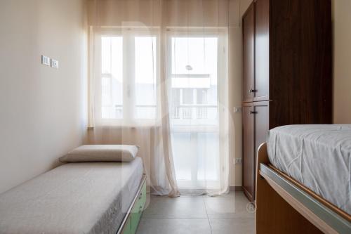 a bedroom with a bed and a window at Homiday - Appartamento Via Roma, 32 in Pineto