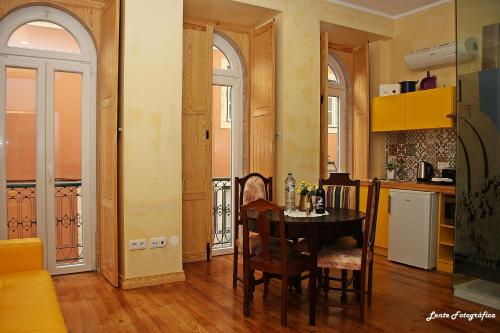 a kitchen with a table and chairs in a room at Sao Jorge Apartments & Suites in Lisbon