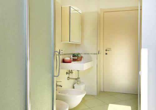 a bathroom with a toilet and a sink at Holihome Hill View in Tortoreto Lido