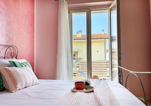 a bedroom with a bed with a plate of food on it at Holihome Hill View in Tortoreto Lido