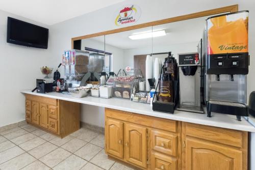 a kitchen with a counter with bottles of beer on it at Super 8 by Wyndham Winner SD in Winner
