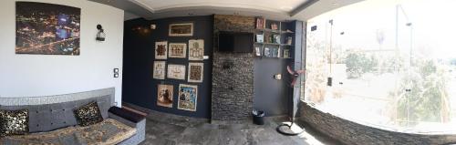 a room with a wall with pictures and a window at H100 Pyramids View in Giza