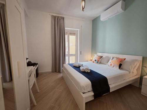 a bedroom with a large white bed with a window at Townhouse 41 - by Be Your Home in Civitavecchia