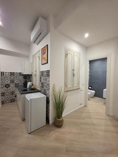 a white kitchen with a sink and a bathroom at Townhouse 41 - by Be Your Home in Civitavecchia