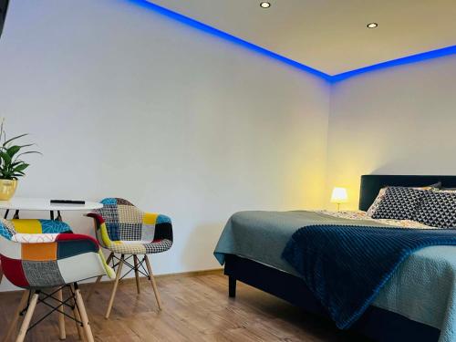 a bedroom with a bed and a table and chairs at ApartamentyM&K in Balice