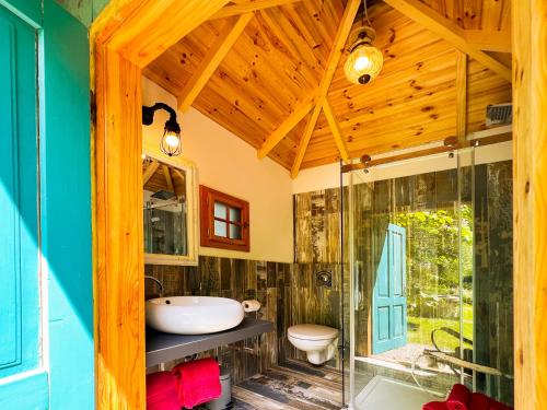a bathroom with a sink and a glass shower at Park am See in Obertraun