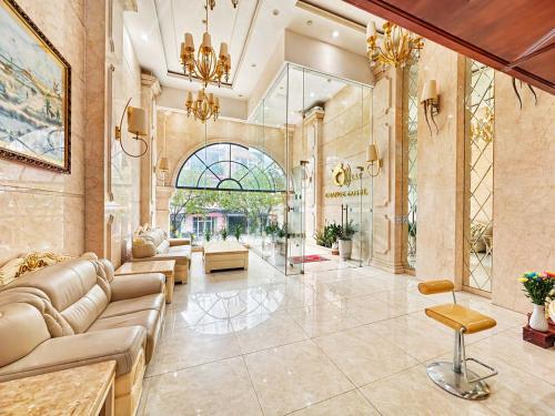 a living room with a couch and a table at Orange City Center Hotel Da Nang - Near Han Market & Dragon Brigde in Danang