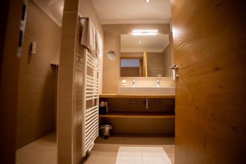a bathroom with a sink and a mirror at Apartments Oberdorner in Lagundo