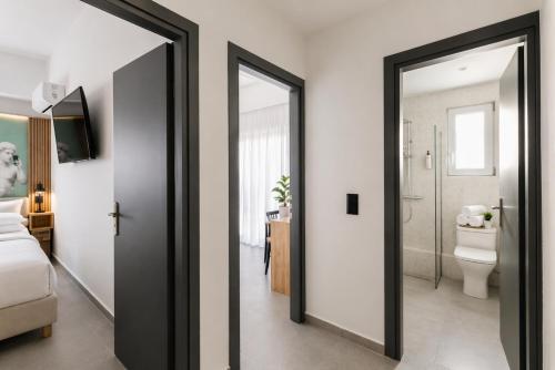 a room with a bathroom with a toilet and a mirror at The Q Hotel in Athens