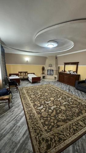 a large room with a large rug on the floor at Aruzhan Hostel in Shymkent
