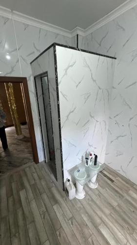 a bathroom with a sink and a mirror at Aruzhan Hostel in Shymkent
