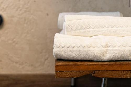a stack of white towels sitting on top of a table at Domus Mea Suites in Costermano