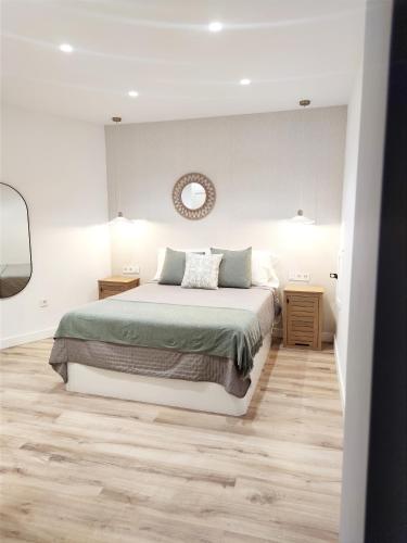 a bedroom with a bed and a clock on the wall at Luz de Belén in Jaén