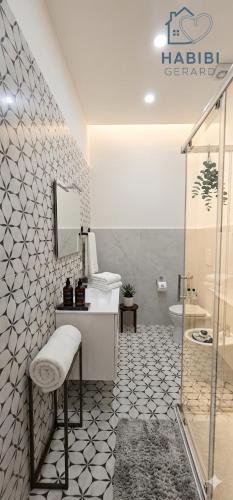 a bathroom with a toilet and a sink and a shower at Habibi Gerard in Torre del Greco