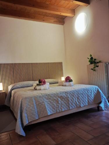 a bedroom with a bed with two pillows on it at Respiro di Lago - Pool Friend in Paratico