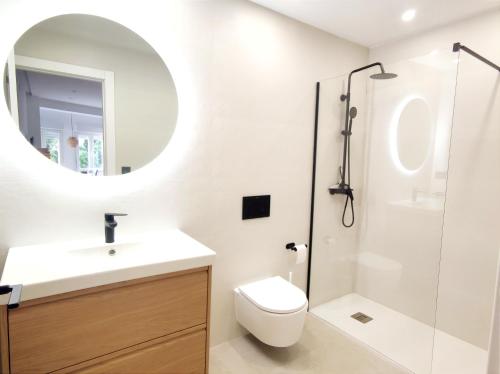 a bathroom with a sink and a toilet and a mirror at Luz de Belén in Jaén