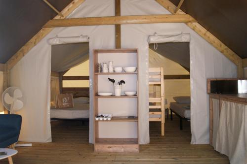 a room with a tent with two beds at Le Beau Vezé in Carqueiranne