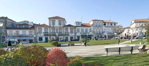 a large building with a park in front of it at Residencial Deu-La-Deu by Hotel Dom Afonso in Monção