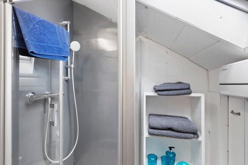 a bathroom with a shower and some blue towels at Fewo Kurt in Villingen-Schweninngen in Villingen-Schwenningen