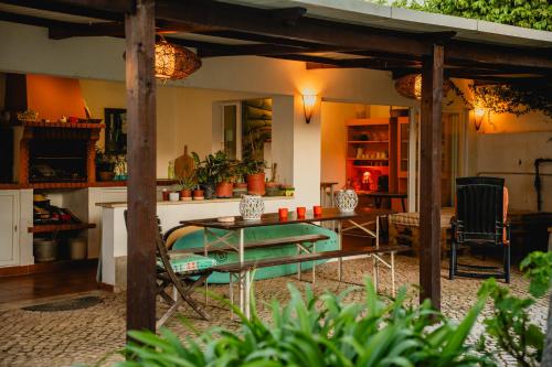 a living room with a table and chairs and a table sidx sidx at Casa do Marmeleiro Guest House Cascais in Cascais