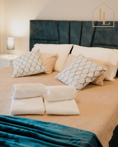 a large bed with white pillows on it at Casa da Amorosa com Vista Mar by Lethes Legacy in Abelheira
