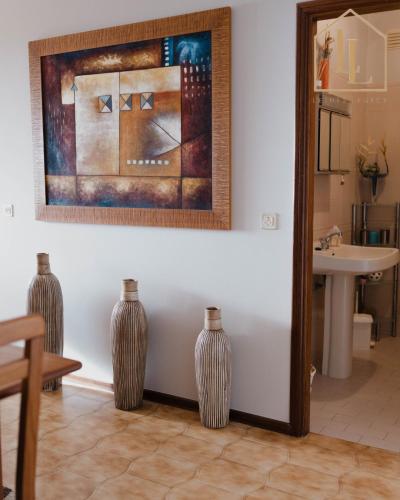 three vases sitting next to a bathroom with a sink at Casa da Amorosa com Vista Mar by Lethes Legacy in Abelheira
