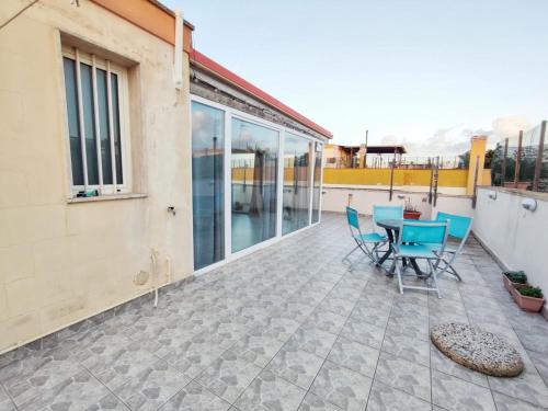 a patio with chairs and a table on a building at Terrazza Lumière in Alezio
