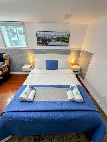 a bedroom with a large bed with towels on it at Spacious room near subway & shops in Toronto