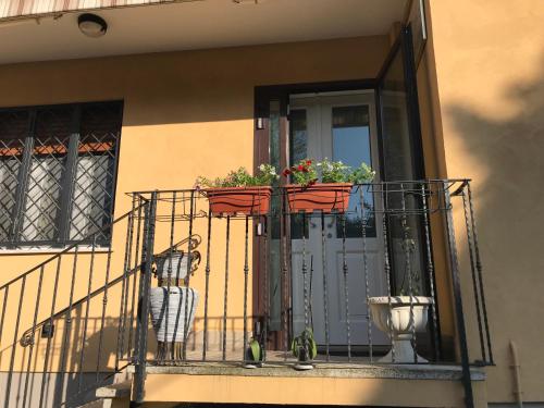 a balcony with two potted plants on a door at R&B MiDora Montale in Montale