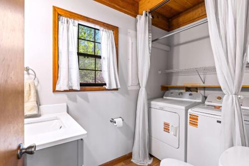 a laundry room with a washer and dryer and a window at Making Memories in Blairsville