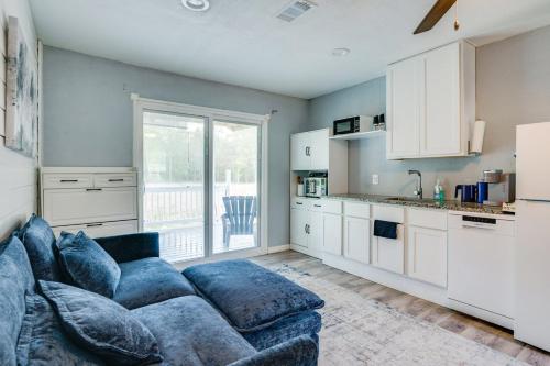 a living room with a blue couch and a kitchen at Country Hideaway For A True Getaway in Montgomery