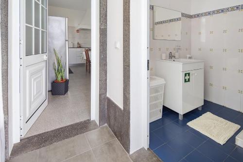 a small bathroom with a sink and a toilet at Carmen's Place in Ponta Garça