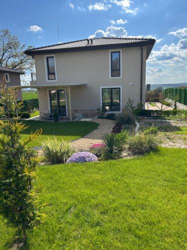 a house with a yard with green grass at Villa Belvedere in Varna City