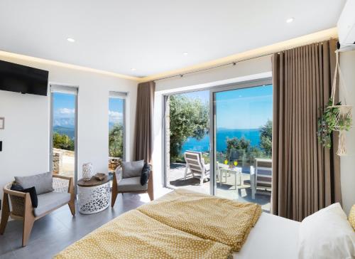 a bedroom with a bed and a view of the ocean at Grey Sea View Estate - Luxury Villas with Private Pool & Plunge Pool in Katouna