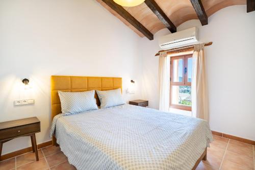 a bedroom with a bed and a window at Villa Sa Costa - Families or Couples Only in Calvià