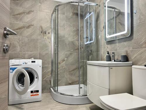 a bathroom with a washing machine and a washer at Alezzi Beach Resort - Sea View Suite in Mamaia Sat/Năvodari