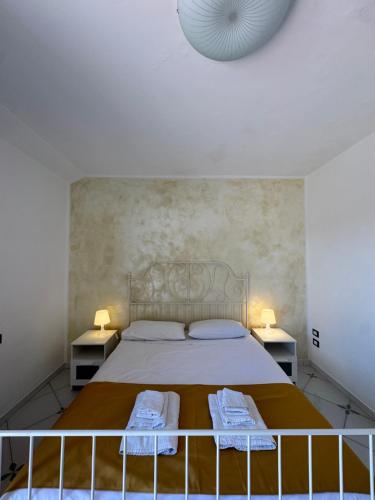 a bedroom with a large bed with two night stands at Villa Setharè in Salerno