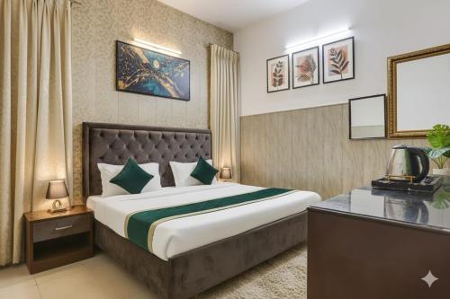 a hotel room with a bed and a television at hotel grand vk #Ac family rooms#free wifi#free parking in Agra