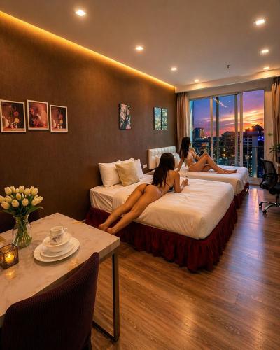 two women laying on beds in a hotel room at Crystal Suites at Ramad KLCC in Kuala Lumpur