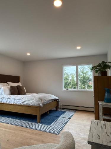 a bedroom with a bed and a window at Azur East, Southampton in Southampton