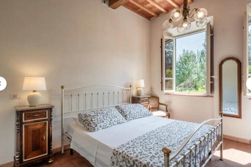 a bedroom with a bed and a window at Charming LUCCA in Lucca