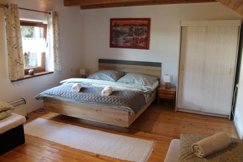 a bedroom with a bed with two pillows on it at Vilka Tkáč in Kvačany