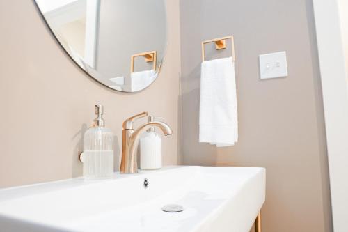 a white bathroom with a sink and a mirror at Hotel Whiskey in Long Beach in Long Beach